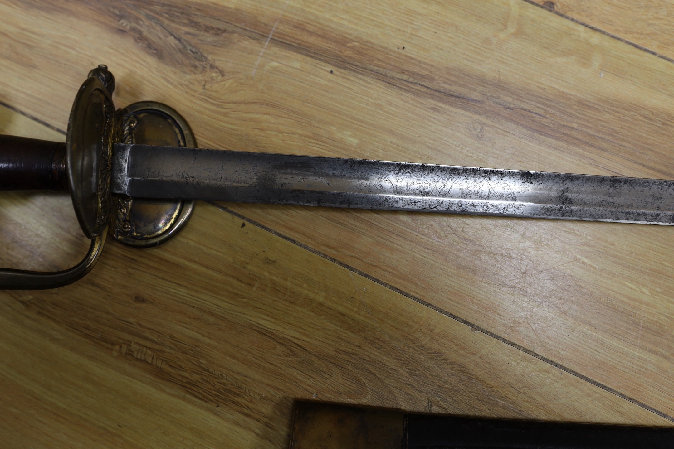 An 18th century European brass hilted sword and scabbard. 89cm long